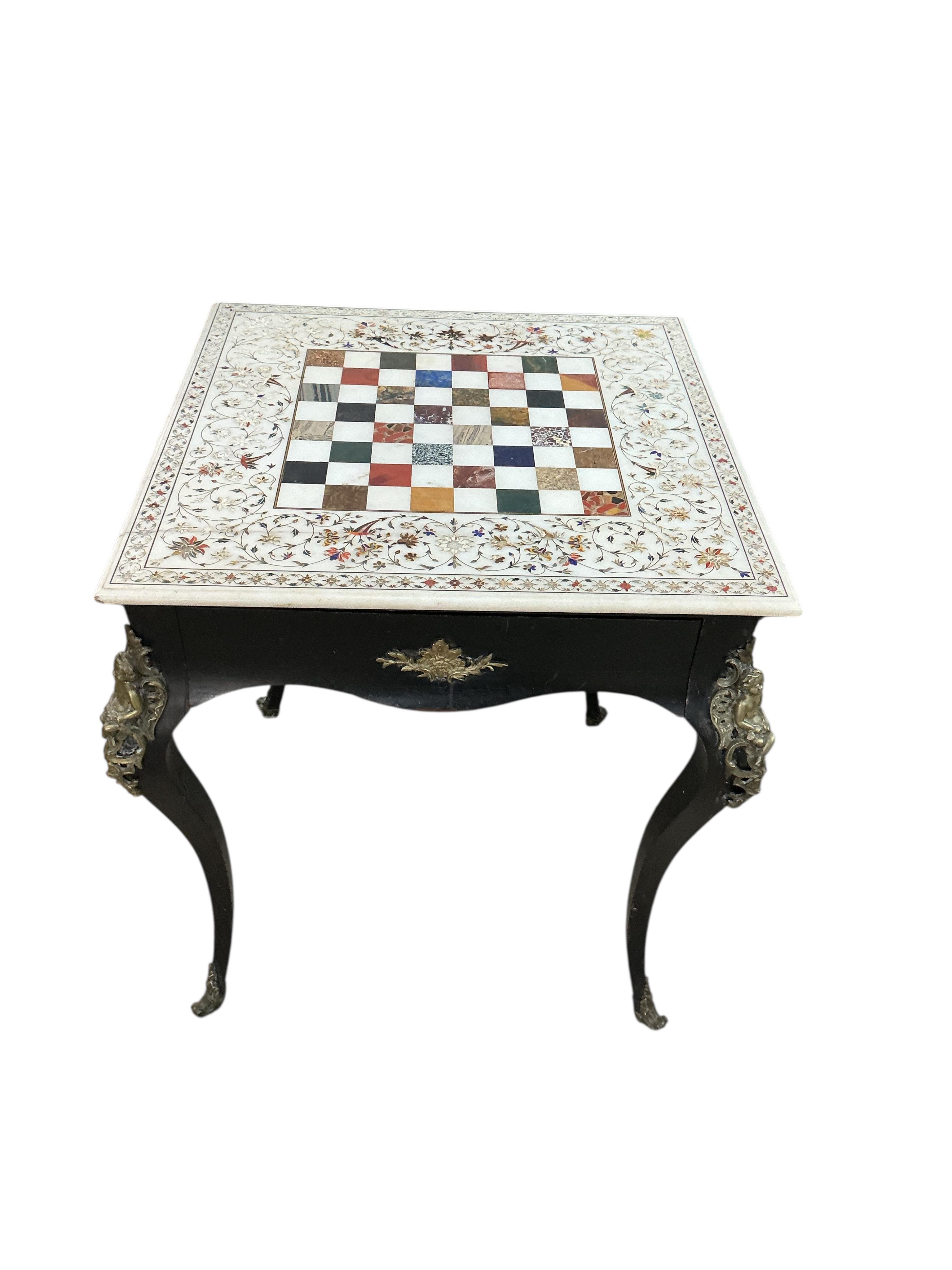 An Indian specimen marble chess set on an earlier associated gilt metal ebonised stand, width 68cm, height 74cm